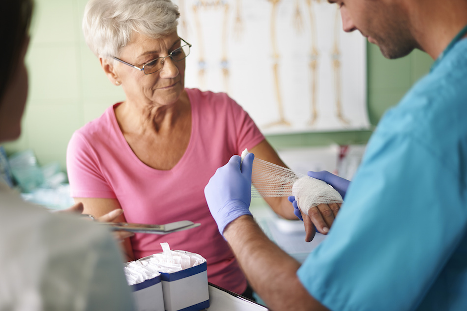 senior woman with bandage on her hand